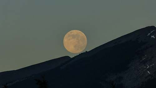 moon silhouette of mountains with moon background night